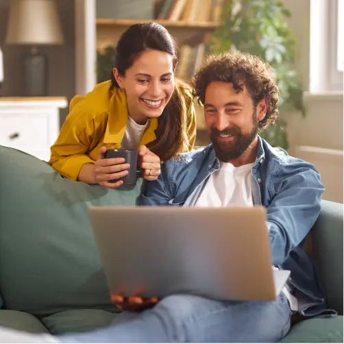 Eine Frau und ein Mann suchen online nach günstigem Ökostrom.